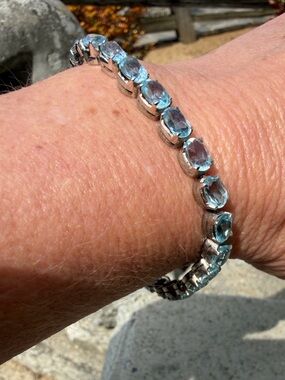 Gorgeous, never worn Blue Topaz Tennis Bracelet set in sterling silver